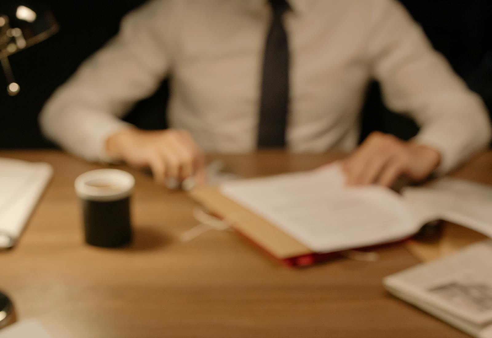 Warm professional desk with business documents and coffee
